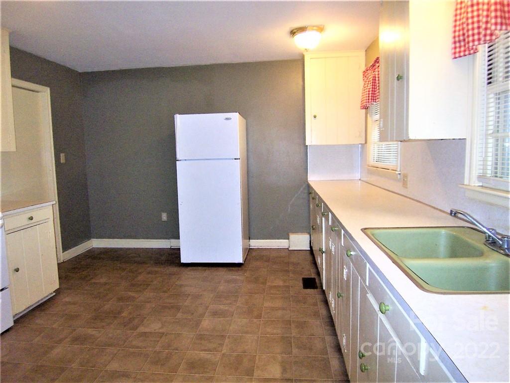 4529 Fallston Road Lawndale, NC 28090 - Photo 13 of 38 a kitchen with kitchen island granite countertop a sink and a refrigerator