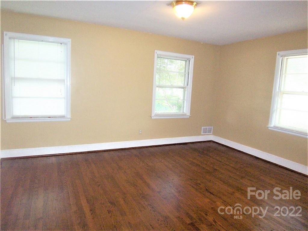 4529 Fallston Road Lawndale, NC 28090 - Photo 18 of 38 an empty room with wooden floor and windows