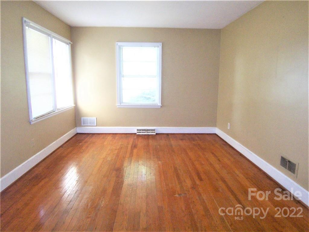 4529 Fallston Road Lawndale, NC 28090 - Photo 22 of 38 an empty room with wooden floor and windows