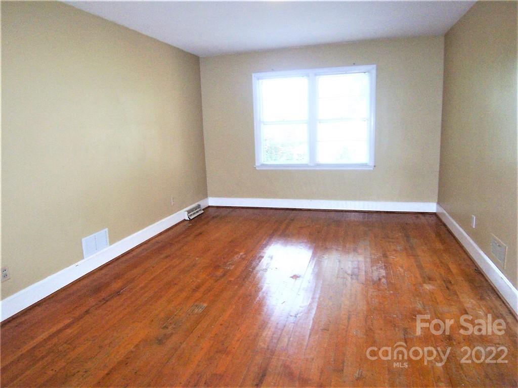 4529 Fallston Road Lawndale, NC 28090 - Photo 24 of 38 an empty room with wooden floor and windows