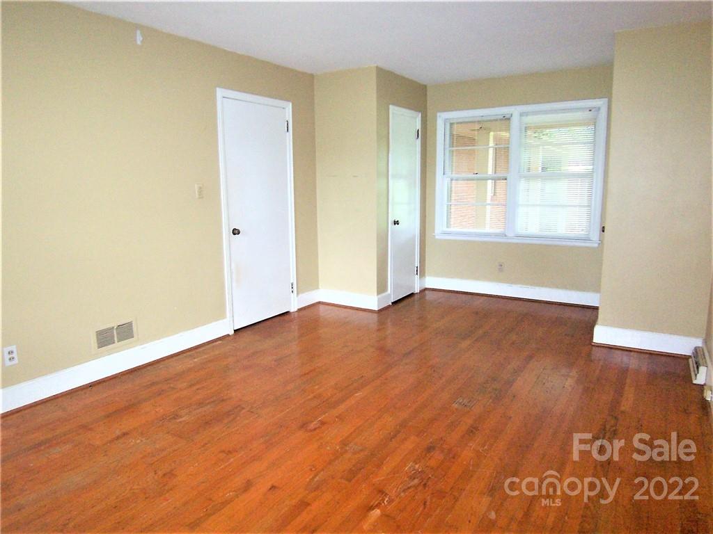 4529 Fallston Road Lawndale, NC 28090 - Photo 25 of 38 an empty room with wooden floor and windows