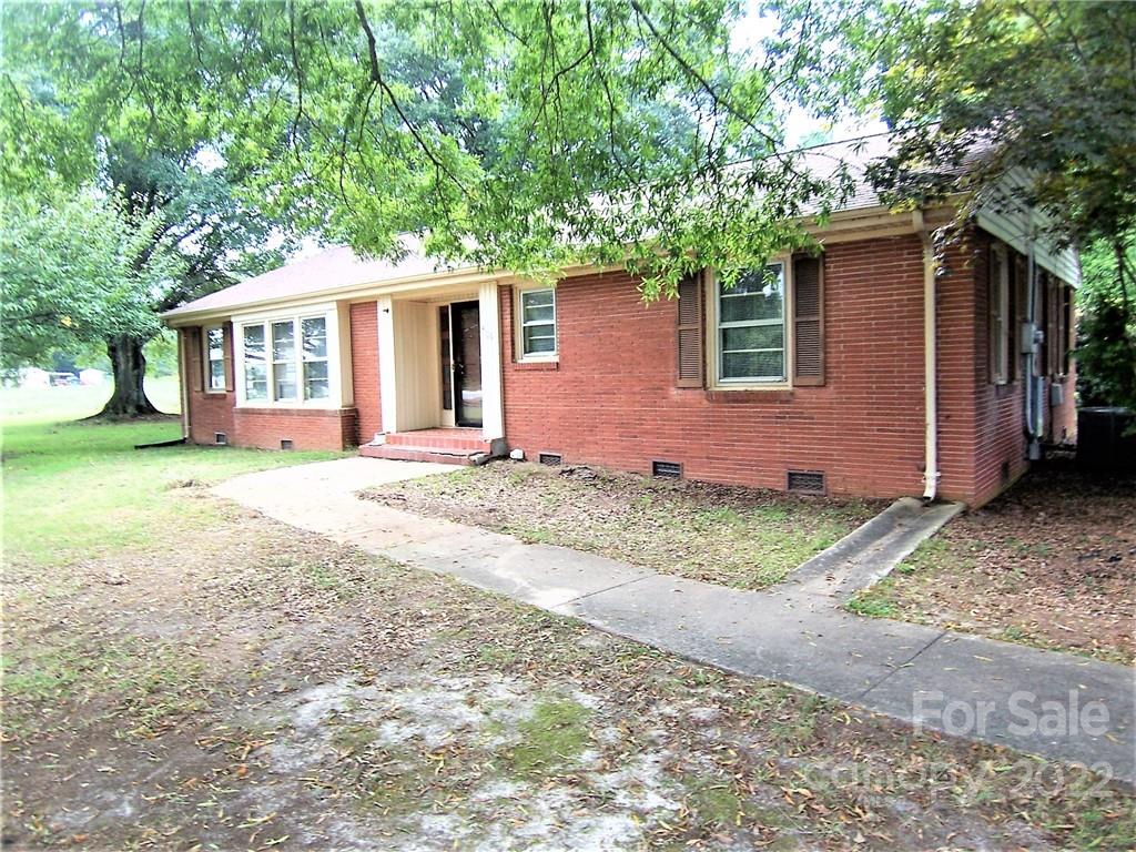 4529 Fallston Road Lawndale, NC 28090 - Photo 3 of 38 a front view of a house with a yard and garage