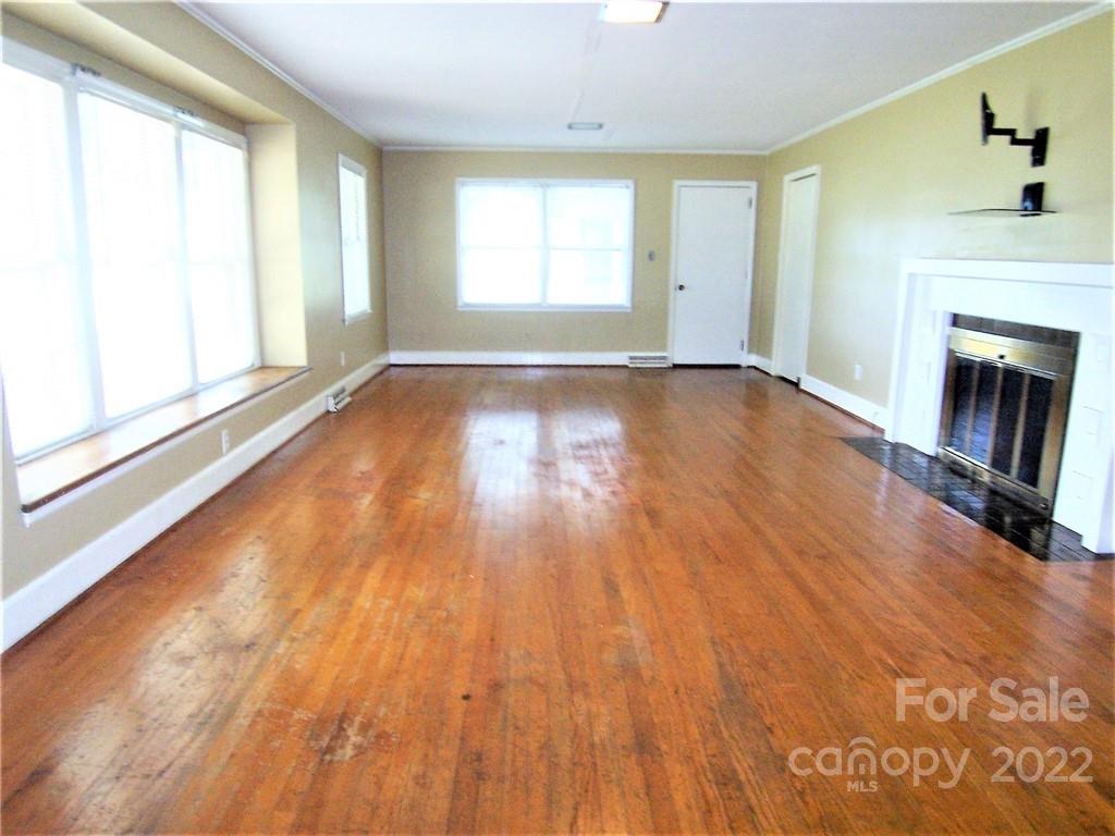 4529 Fallston Road Lawndale, NC 28090 - Photo 6 of 38 a view of empty room with wooden floor and fireplace