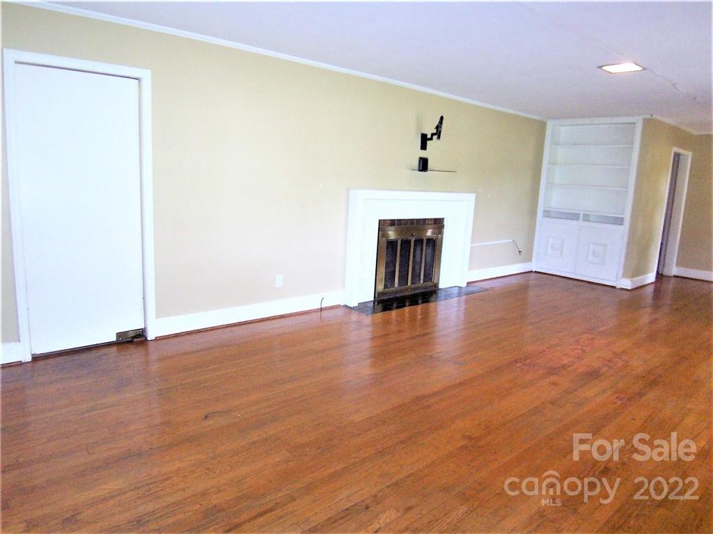 4529 Fallston Road Lawndale, NC 28090 - Photo 8 of 38 a view of an empty room with wooden floor and a fireplace