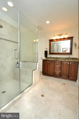 a bathroom with a tub sink and mirror