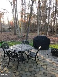 a backyard of a house with table and chairs