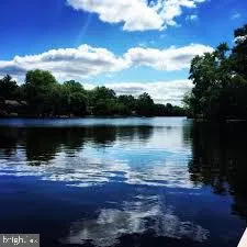 a view of a lake with houses in the back