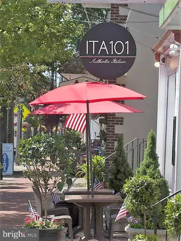 a view of outdoor space with a table and chairs under an umbrella