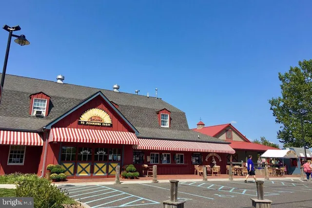 a front view of a building with parking area