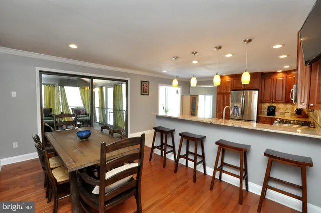a view of a dining room with furniture and wooden floor