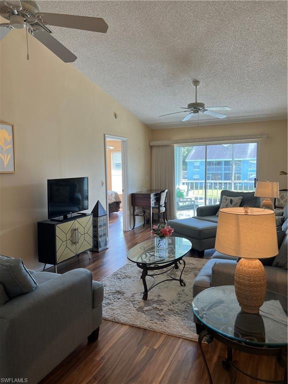 185 Grand Oaks Way, Unit R204 Naples, FL 34110 - Photo 9 of 18 a living room with furniture and a flat screen tv