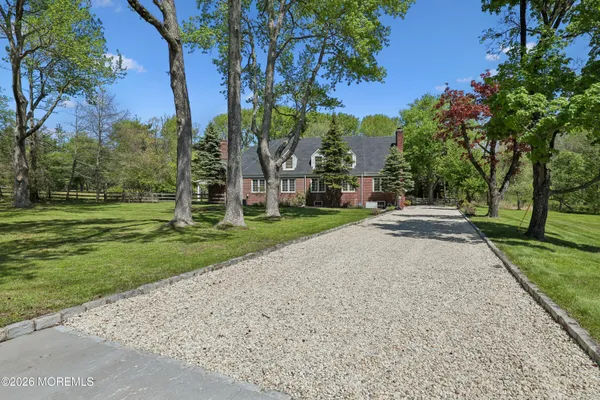a front view of house with yard and green space