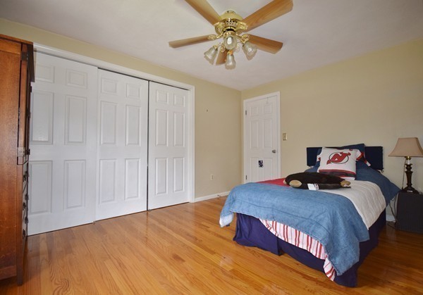 175 Tinkham Road Springfield, MA 01129 - Photo 18 of 30 a bedroom with a large bed and a chandelier