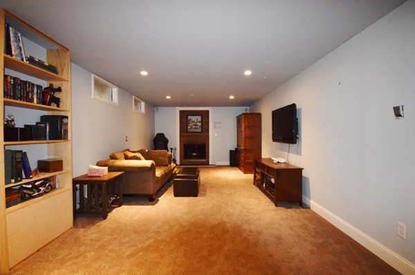 175 Tinkham Road Springfield, MA 01129 - Photo 22 of 30 a living room with furniture a flat screen tv and a book shelf