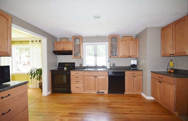 175 Tinkham Road Springfield, MA 01129 - Photo 4 of 30 a kitchen with granite countertop a stove top oven sink and cabinets