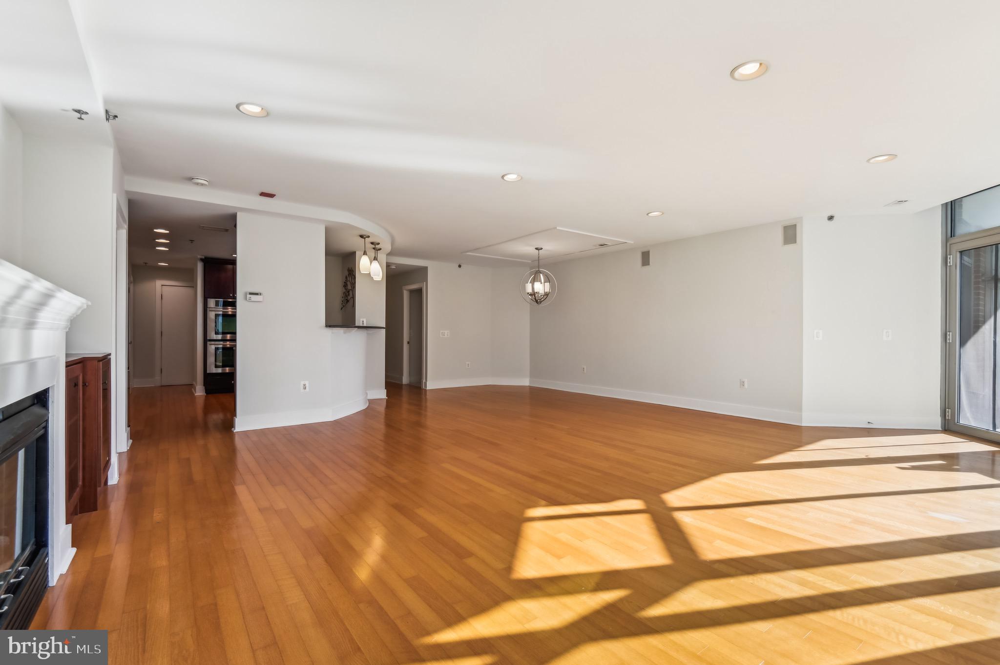 1400 Lancaster Street, Unit 502 Baltimore, MD 21231 - Photo 7 of 48 a view of empty room with wooden floor and fan