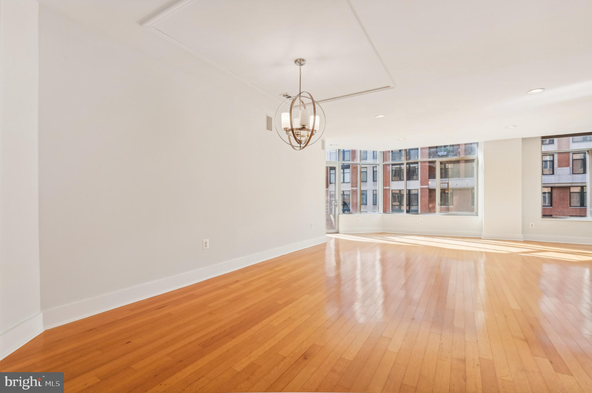 1400 Lancaster Street, Unit 502 Baltimore, MD 21231 - Photo 9 of 48 a view of empty room with wooden floor and fan