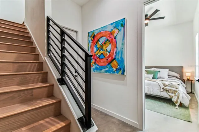 a kitchen with stainless steel appliances granite countertop a sink a stove and chairs with wooden floor