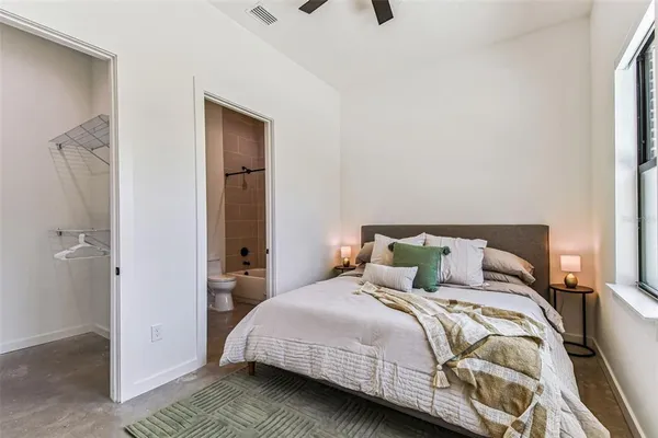 a kitchen with stainless steel appliances granite countertop a refrigerator a oven a stove and a wooden floors