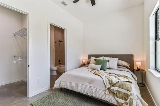 a kitchen with stainless steel appliances granite countertop a refrigerator a oven a stove and a wooden floors