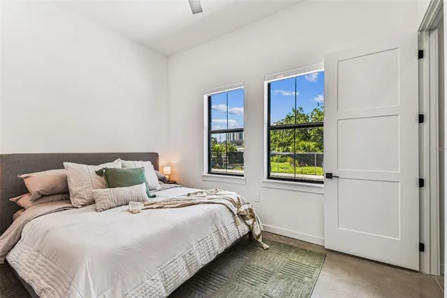 a kitchen with stainless steel appliances granite countertop a stove a refrigerator a kitchen island a dining table and chairs with wooden floor