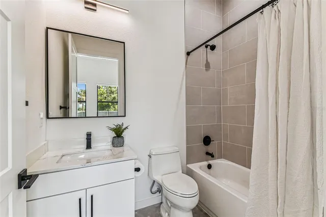 a kitchen with stainless steel appliances granite countertop a refrigerator a sink dishwasher and a stove with wooden floor