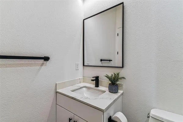 a kitchen with a sink a chandelier and living room view