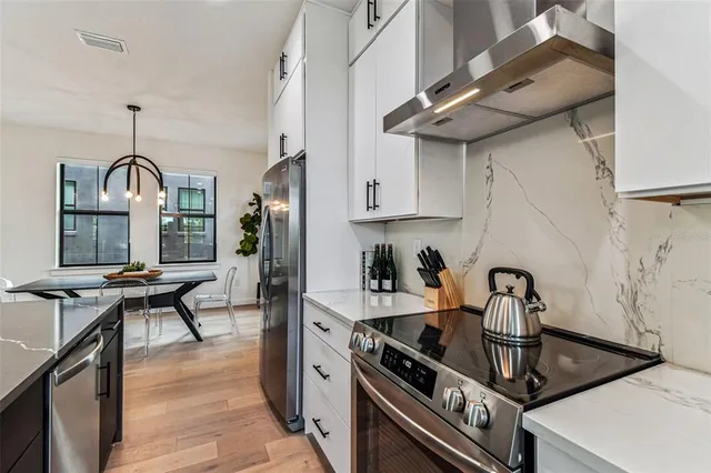 a view of a room with furniture and wooden floor