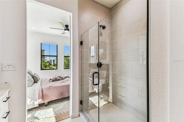 an aerial view of a city with lots of residential buildings ocean and mountain view in back