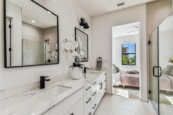 a bedroom with a bed and windows