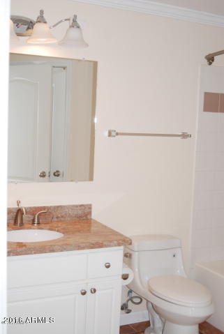 1701 East Colter Street, Unit 333 Phoenix, AZ 85016 - Photo 17 of 36 a bathroom with a granite countertop sink and a toilet