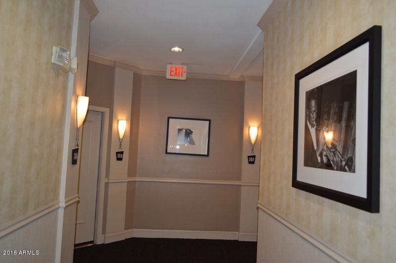 1701 East Colter Street, Unit 333 Phoenix, AZ 85016 - Photo 26 of 36 a view of a hallway with paintings on the wall
