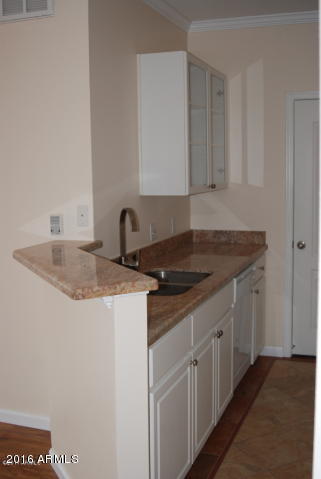 1701 East Colter Street, Unit 333 Phoenix, AZ 85016 - Photo 7 of 36 a kitchen with a sink and cabinets