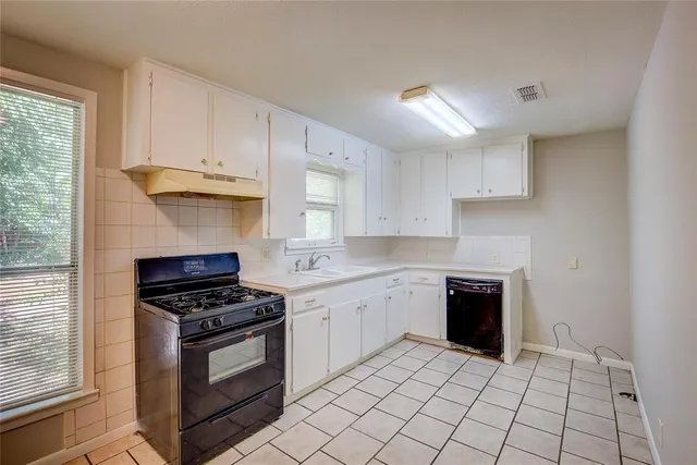 a kitchen with stainless steel appliances granite countertop a sink and a stove