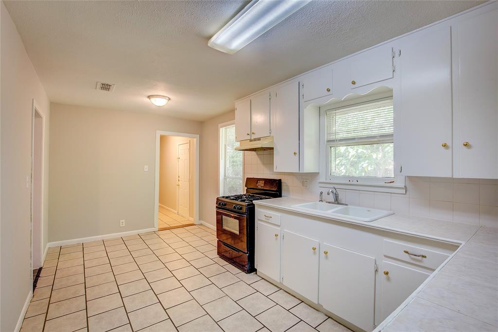 620 Harrison Lane Hurst, TX 76053 - Photo 12 of 32 a kitchen with stainless steel appliances granite countertop a sink and a stove