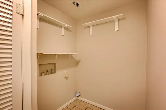 an empty room with window and ceiling fan