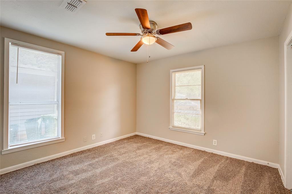 620 Harrison Lane Hurst, TX 76053 - Photo 15 of 32 an empty room with window and ceiling fan