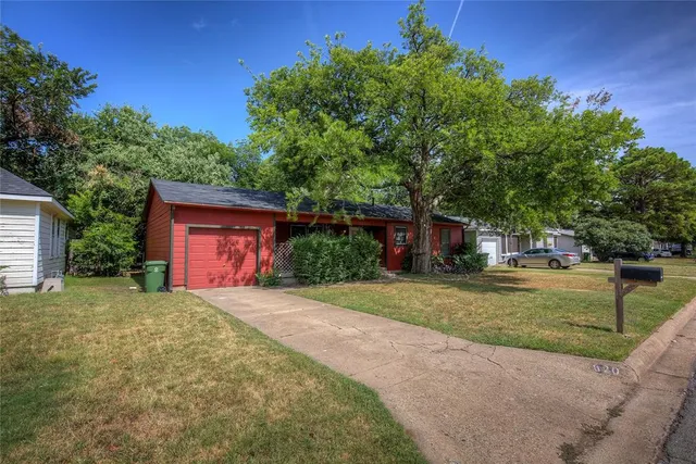 a front view of a house with a yard and a garage