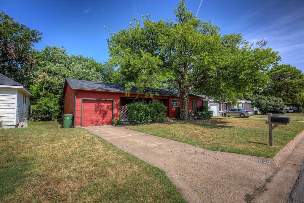 620 Harrison Lane Hurst, TX 76053 - Photo 2 of 32 a front view of a house with a yard and a garage