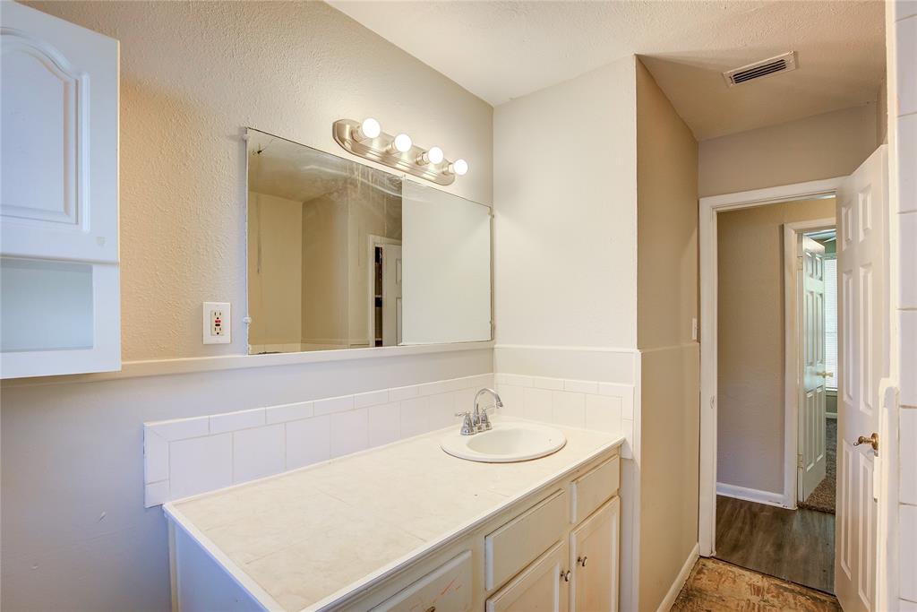 620 Harrison Lane Hurst, TX 76053 - Photo 21 of 32 a bathroom with a sink and a mirror