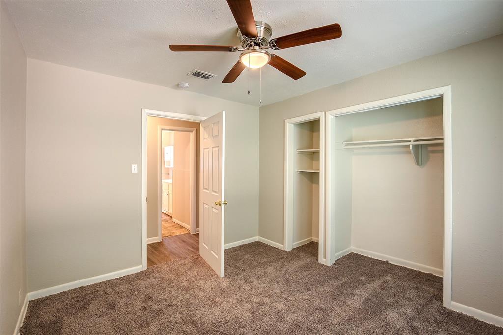 620 Harrison Lane Hurst, TX 76053 - Photo 23 of 32 an empty room with closet and a ceiling fan