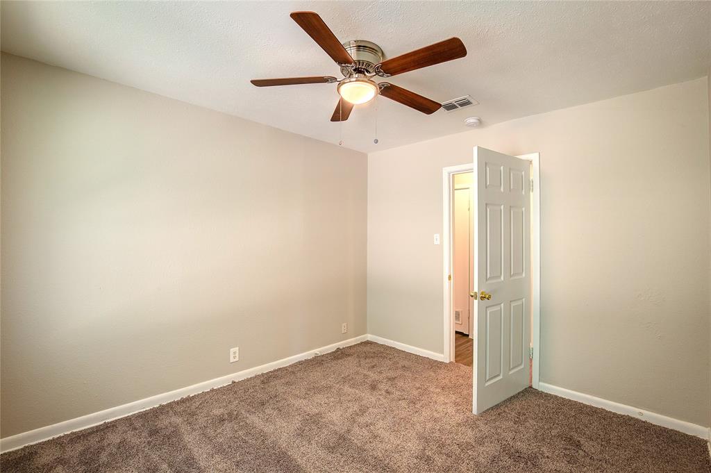 620 Harrison Lane Hurst, TX 76053 - Photo 24 of 32 an empty room with closet and windows