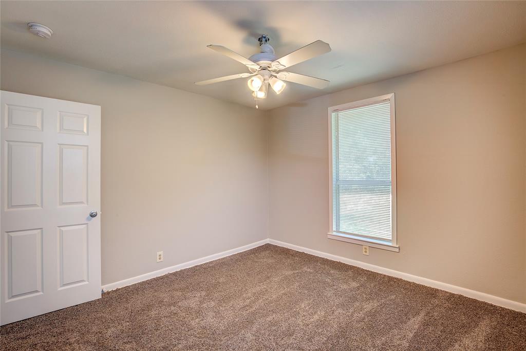 620 Harrison Lane Hurst, TX 76053 - Photo 27 of 32 an empty room with windows and fan