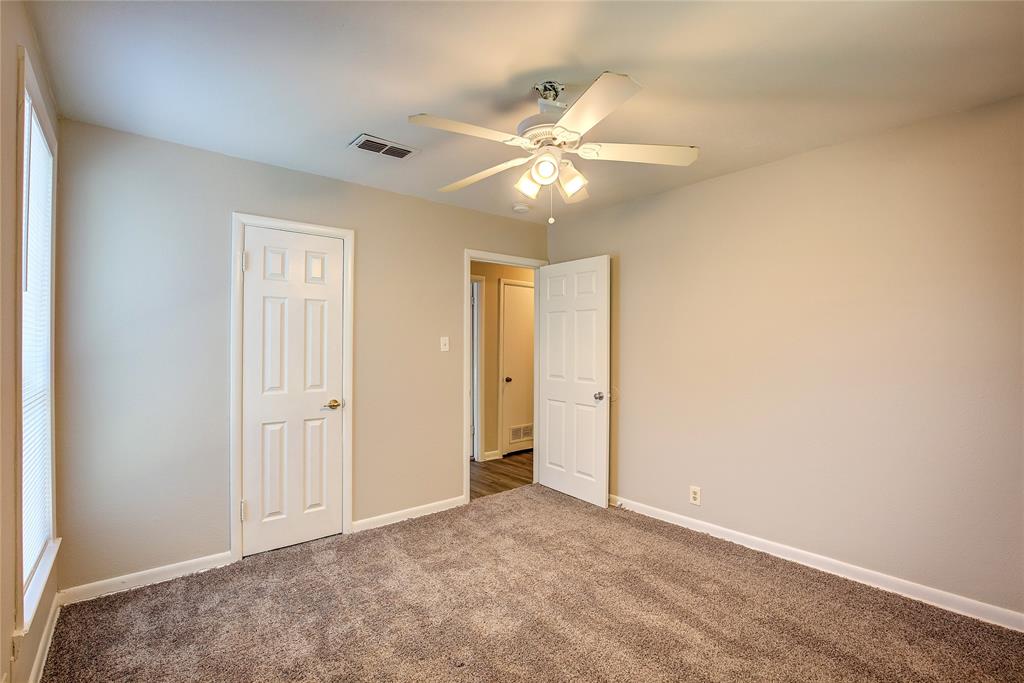 620 Harrison Lane Hurst, TX 76053 - Photo 28 of 32 an empty room with a ceiling fan and a window