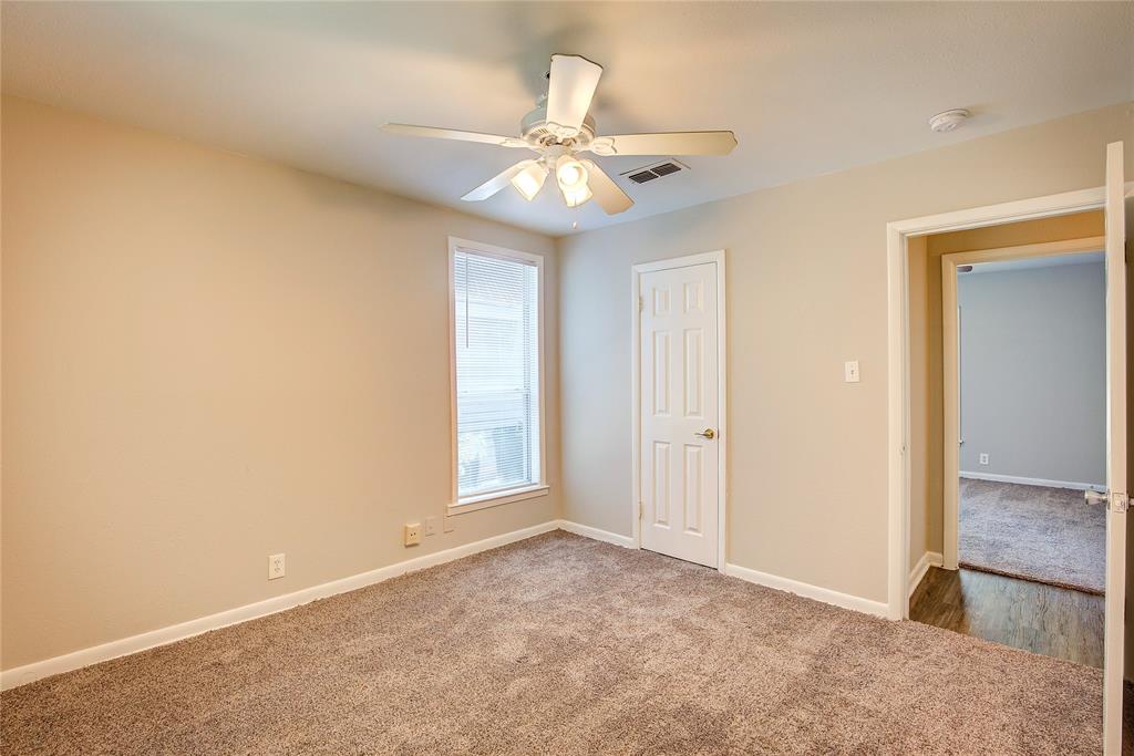 620 Harrison Lane Hurst, TX 76053 - Photo 29 of 32 an empty room with closet and a chandelier fan