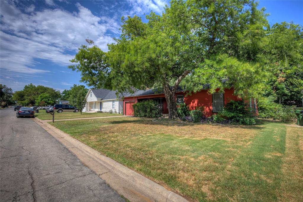 620 Harrison Lane Hurst, TX 76053 - Photo 3 of 32 a front view of a house with a yard and a garage