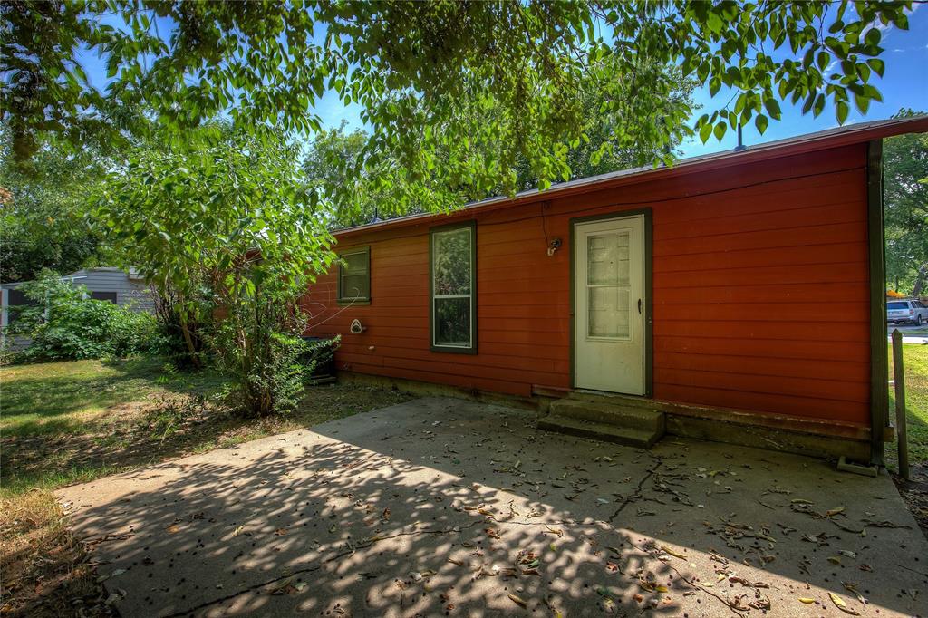 620 Harrison Lane Hurst, TX 76053 - Photo 31 of 32 a view of a backyard with plants and large tree
