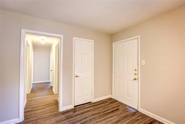 a view of a room with wooden floor