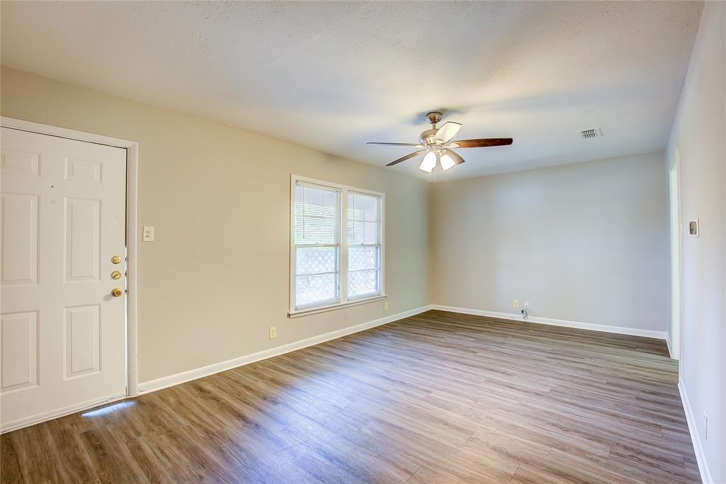 620 Harrison Lane Hurst, TX 76053 - Photo 7 of 32 wooden floor in an empty room with a window