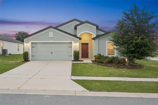 a front view of a house with a yard and garage